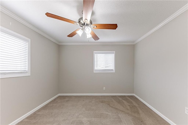empty room featuring a textured ceiling, light colored carpet, baseboards, and ornamental molding