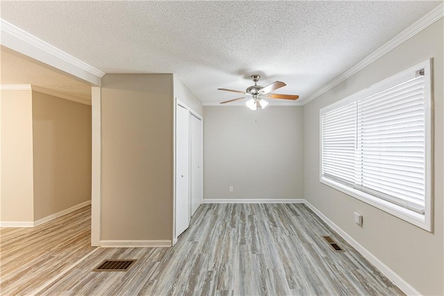 unfurnished room with visible vents, baseboards, and light wood-style floors