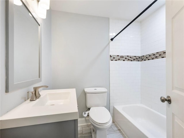 bathroom with baseboards, vanity, toilet, and bathing tub / shower combination