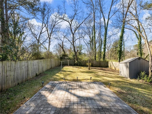 view of yard with a storage shed, a patio area, a fenced backyard, and an outdoor structure