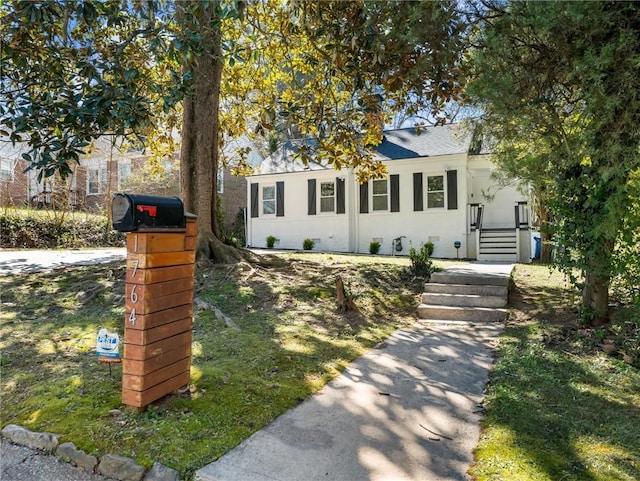 view of front of property with a shingled roof and stucco siding