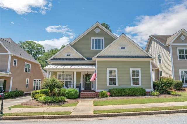 125 Rabbits Run, Fayetteville, GA 30215 - view of front facade featuring covered porch and a standing seam roof