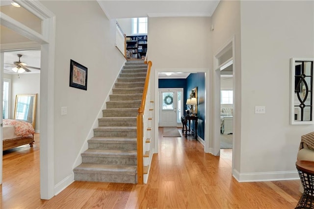 125 Rabbits Run, Fayetteville, GA 30215 - foyer featuring a ceiling fan, healthy amount of natural light, light wood-type flooring, stairway, and ornamental molding