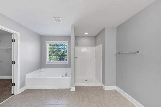 bathroom featuring tile patterned floors and independent shower and bath