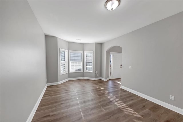 spare room featuring dark hardwood / wood-style flooring