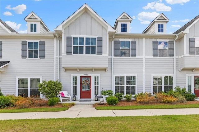 view of property featuring board and batten siding and a front yard