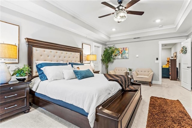 bedroom featuring light carpet, a tray ceiling, crown molding, ceiling fan, and baseboards