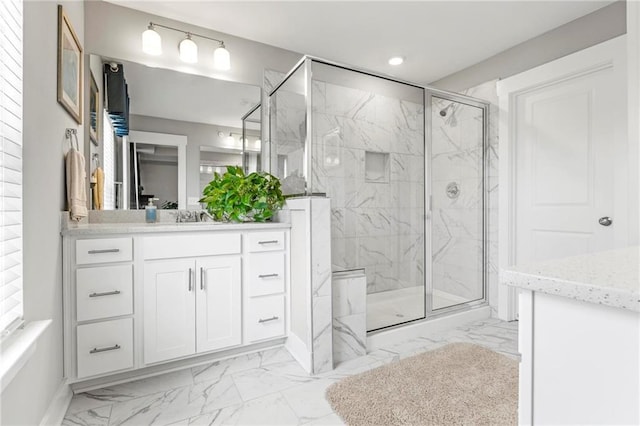 full bathroom with marble finish flooring, a marble finish shower, vanity, and recessed lighting