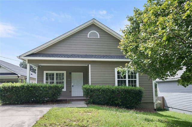 bungalow-style home featuring a porch and a front yard