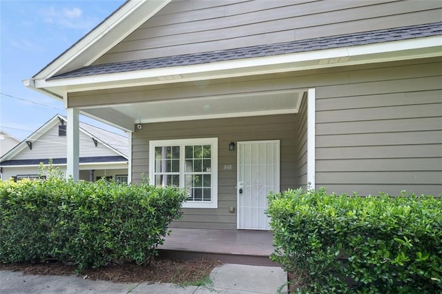 view of exterior entry featuring a porch