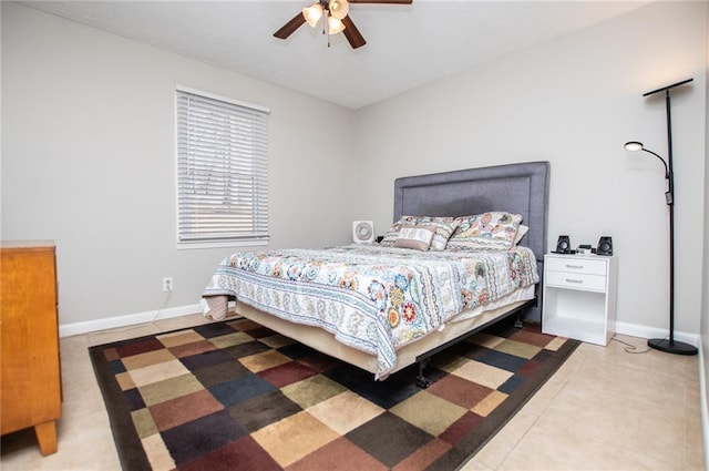 tiled bedroom featuring ceiling fan