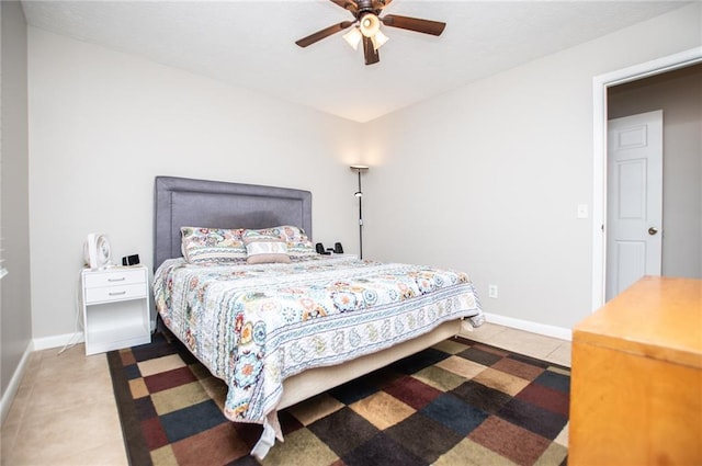 tiled bedroom featuring ceiling fan