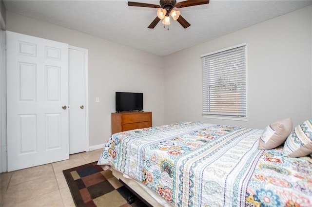 bedroom featuring ceiling fan and light tile patterned flooring