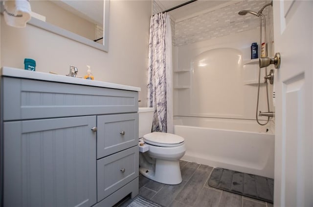 full bathroom with vanity, shower / tub combo with curtain, and toilet