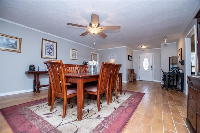 dining room with ceiling fan, crown molding, light hardwood / wood-style floors, and a textured ceiling