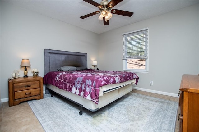 tiled bedroom featuring ceiling fan