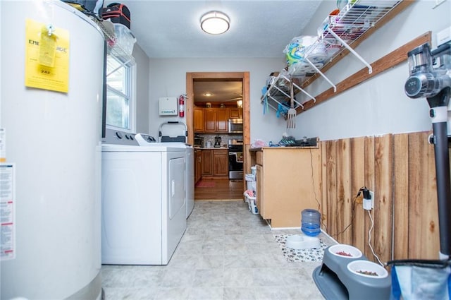 laundry room with washing machine and dryer and water heater