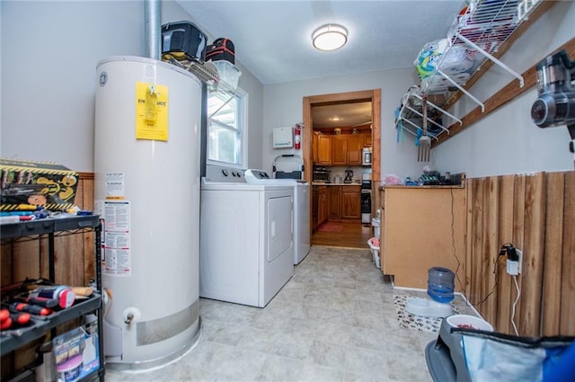 laundry area with gas water heater and washing machine and clothes dryer