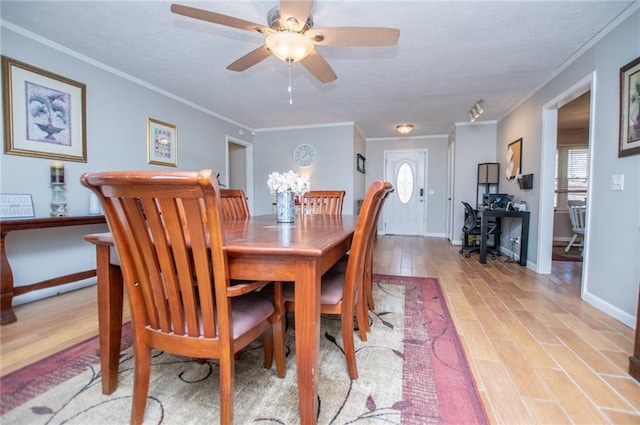 dining space with ceiling fan, ornamental molding, light hardwood / wood-style floors, and a wealth of natural light