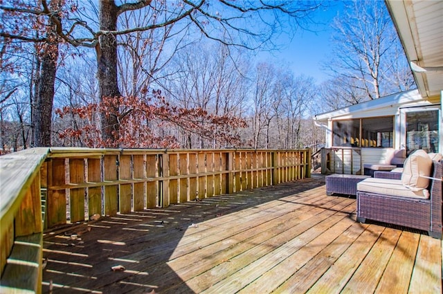 wooden deck with a sunroom and an outdoor hangout area