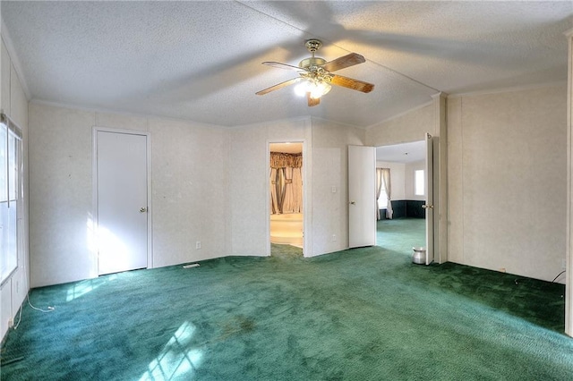 unfurnished room with dark carpet, a textured ceiling, ceiling fan, and vaulted ceiling