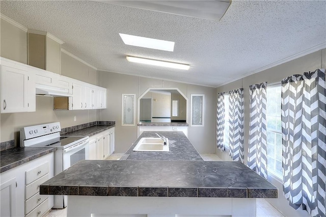 kitchen featuring electric range, a center island, a textured ceiling, and sink