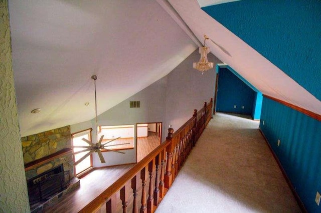 20 Lisa Ct, Stockbridge, GA 30281 - hallway with vaulted ceiling, carpet, a chandelier, and an upstairs landing