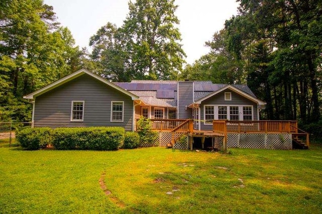 20 Lisa Ct, Stockbridge, GA 30281 - back of property featuring a yard, roof mounted solar panels, a chimney, and a deck