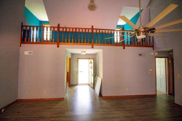 20 Lisa Ct, Stockbridge, GA 30281 - unfurnished living room featuring ceiling fan, wood finished floors, high vaulted ceiling, and baseboards