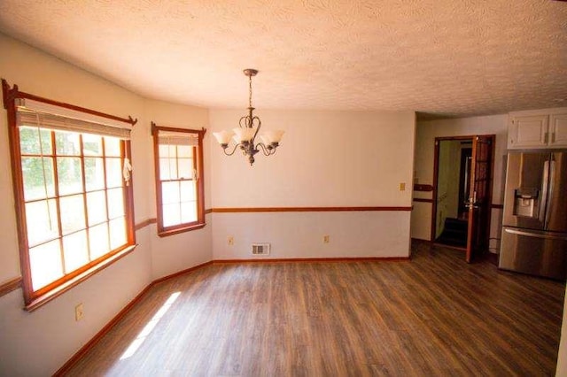 20 Lisa Ct, Stockbridge, GA 30281 - spare room featuring wood finished floors, a chandelier, a textured ceiling, and baseboards