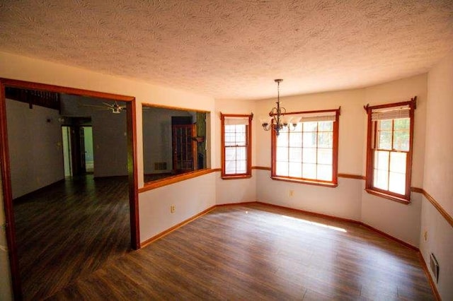 20 Lisa Ct, Stockbridge, GA 30281 - empty room with wood finished floors, a chandelier, a textured ceiling, and baseboards