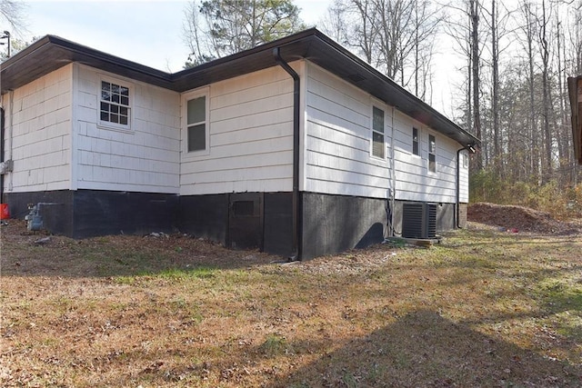 view of side of home featuring central AC