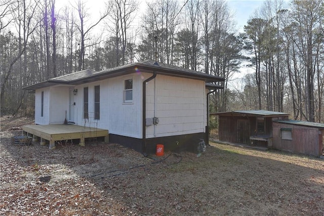 view of property exterior with a deck