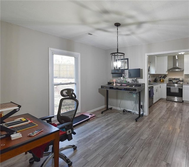 office area featuring visible vents, baseboards, and wood finished floors