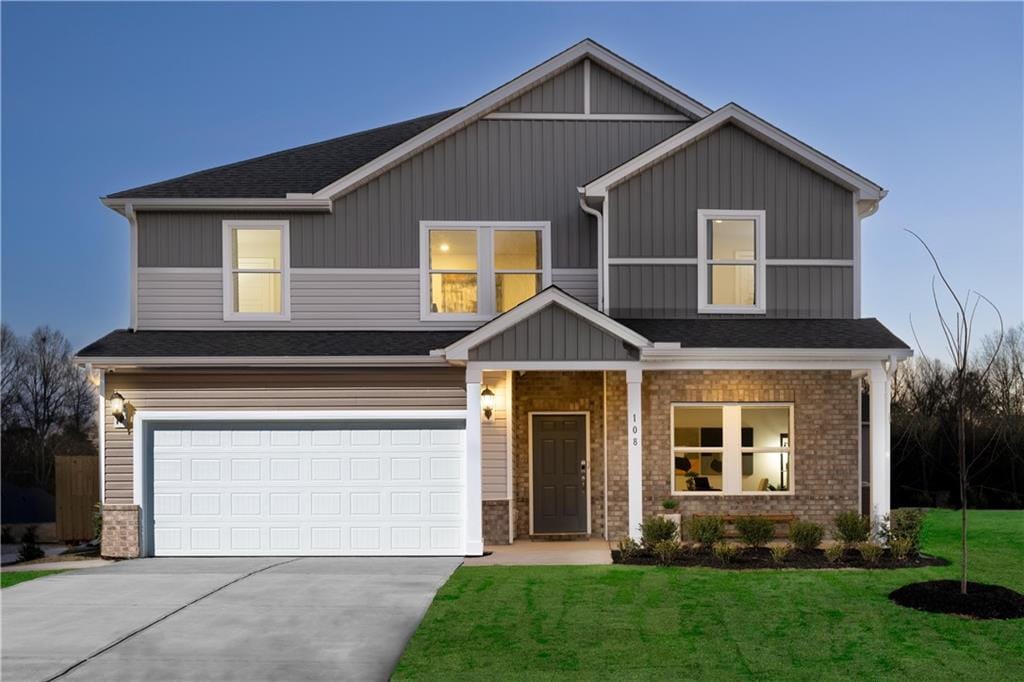 1921 Fairchild Ln, Grayson, GA 30017 - view of front of home with driveway, a garage, a front yard, a shingled roof, and brick siding