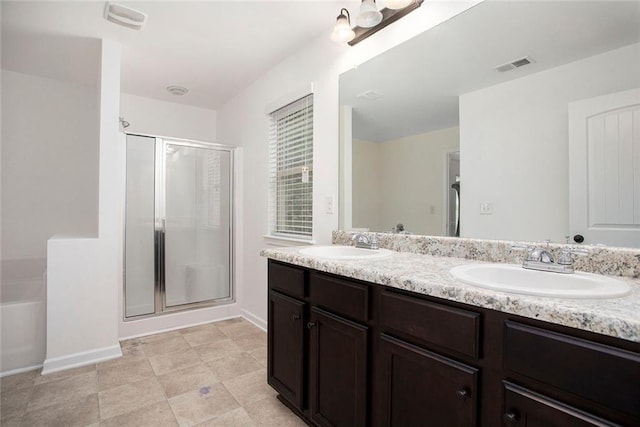 bathroom with vanity and a shower with door