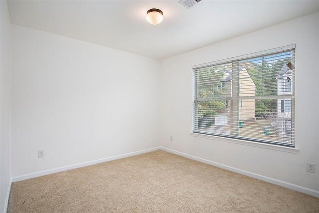 empty room featuring light carpet