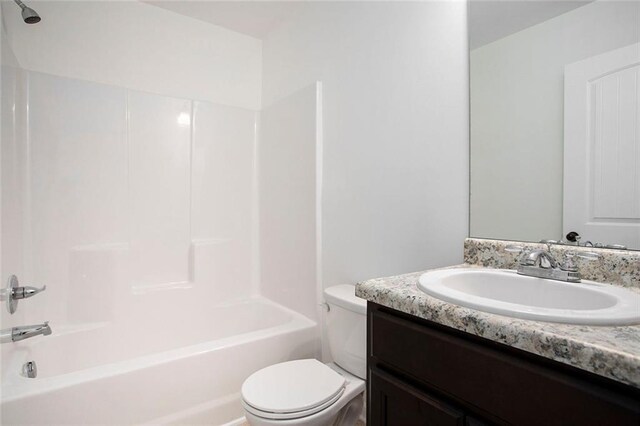 full bathroom with washtub / shower combination, vanity, and toilet