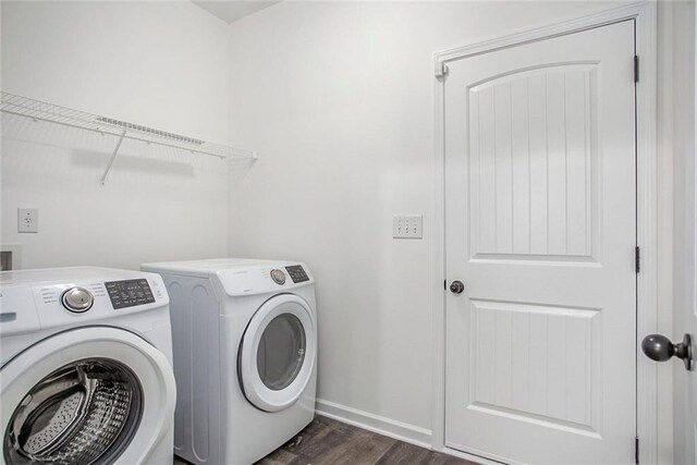 laundry area featuring washer and clothes dryer and dark wood-type flooring