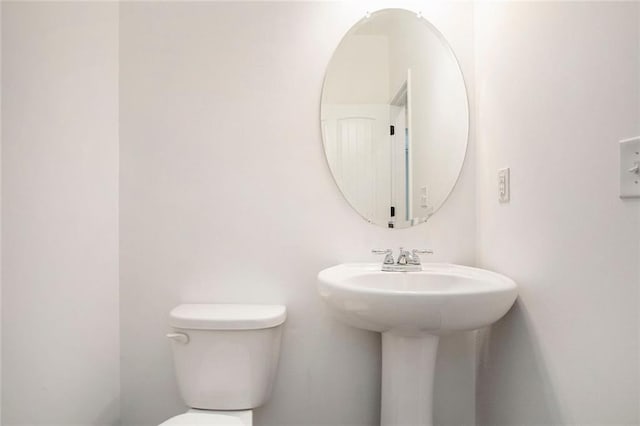 bathroom featuring toilet and sink