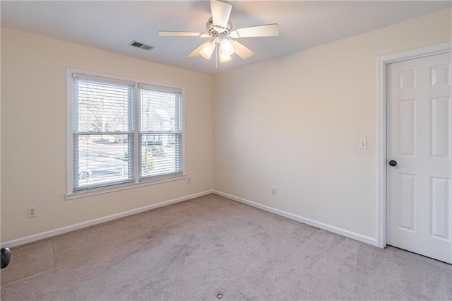 carpeted empty room featuring ceiling fan