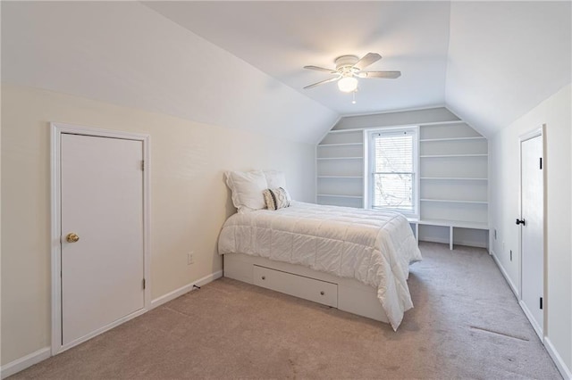 bedroom with ceiling fan, light colored carpet, and lofted ceiling