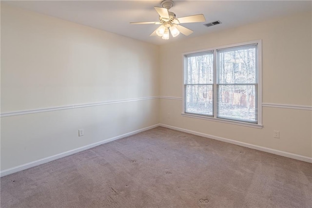 spare room featuring ceiling fan and light carpet