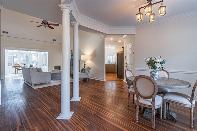 dining space with ceiling fan, crown molding, plenty of natural light, and ornate columns