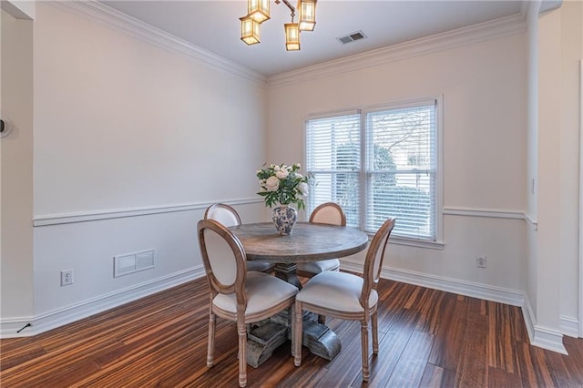 dining room with ornamental molding, plenty of natural light, a notable chandelier, and dark hardwood / wood-style floors