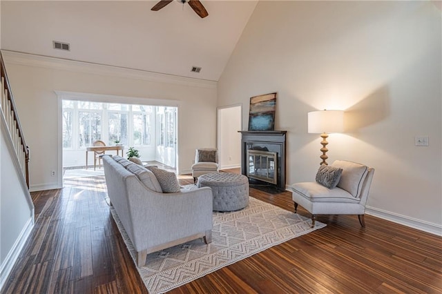 living room with ceiling fan, dark wood-type flooring, and high vaulted ceiling