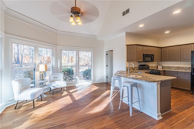 kitchen featuring light stone countertops, black appliances, high vaulted ceiling, ceiling fan, and sink