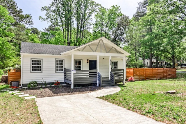 2195 Penelope St NW, Atlanta, GA 30314 - view of front of house with fence, a shingled roof, a front yard, cooling unit, and covered porch