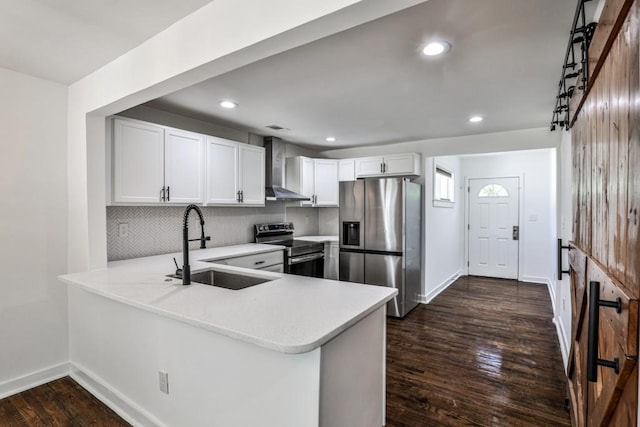 2195 Penelope St NW, Atlanta, GA 30314 - kitchen featuring a sink, light countertops, baseboards, stainless steel appliances, and wall chimney exhaust hood