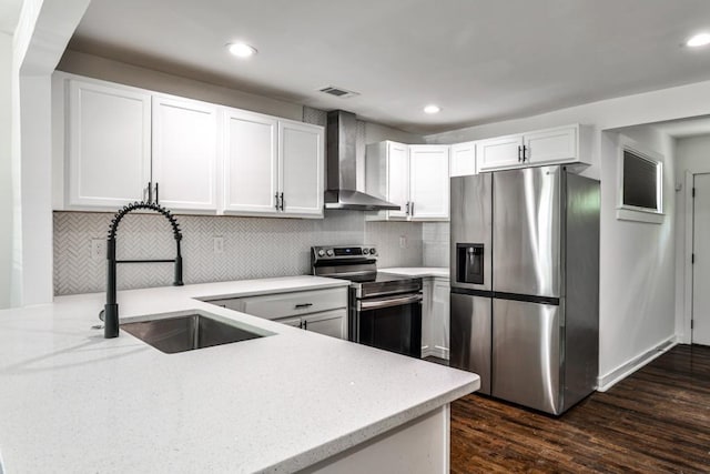 2195 Penelope St NW, Atlanta, GA 30314 - kitchen featuring dark wood-style floors, wall chimney range hood, light stone counters, a sink, and appliances with stainless steel finishes